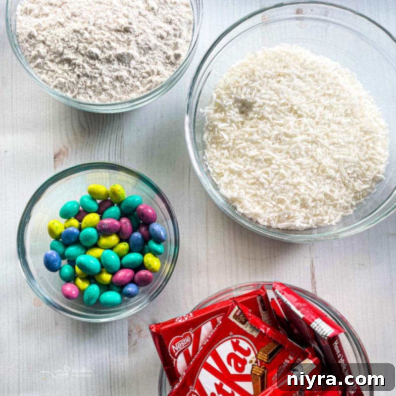 All the essential ingredients for making the Kit Kat Easter Basket Cake laid out neatly on a surface.