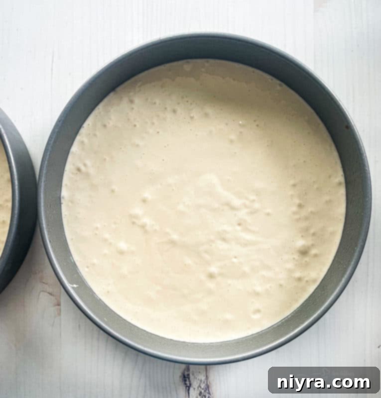 Bowl of yellow cake batter, ready to be poured into pans for the Easter cake.