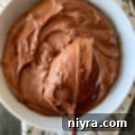 Close up of Sour Cream Chocolate Frosting on a spoon