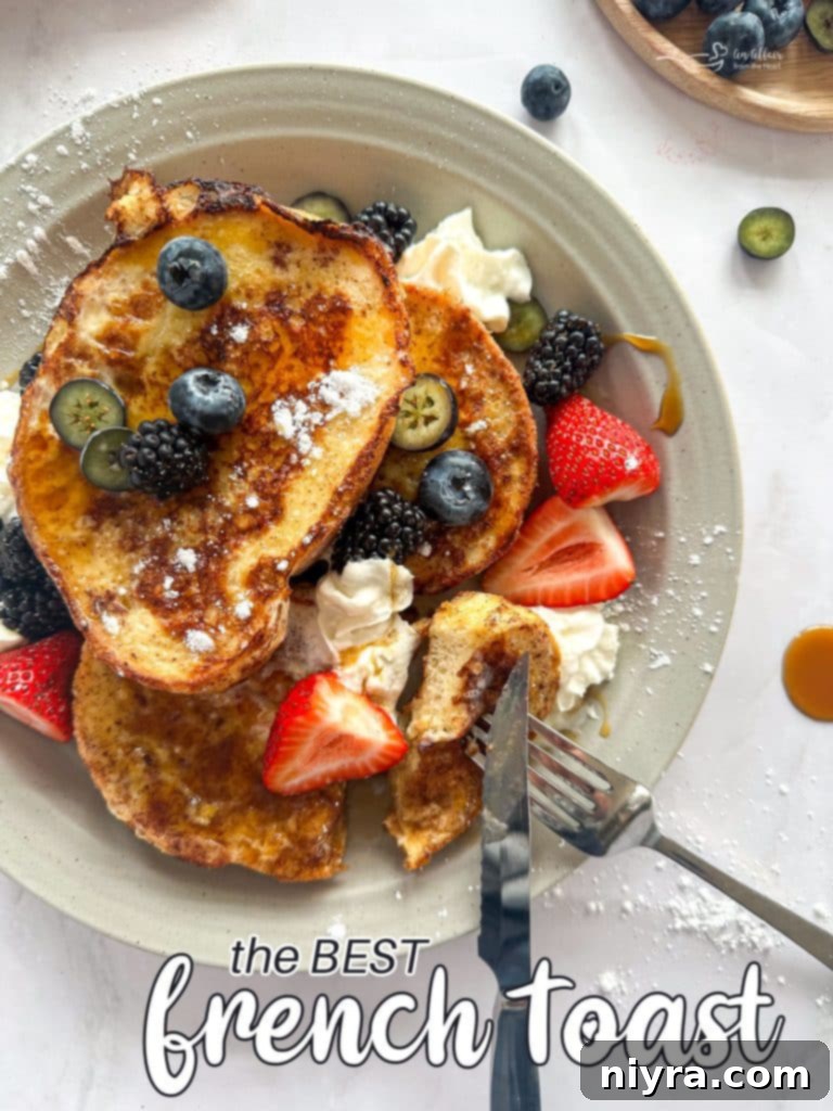 Beautifully presented French Toast with berries, powdered sugar, and syrup, ready to eat.
