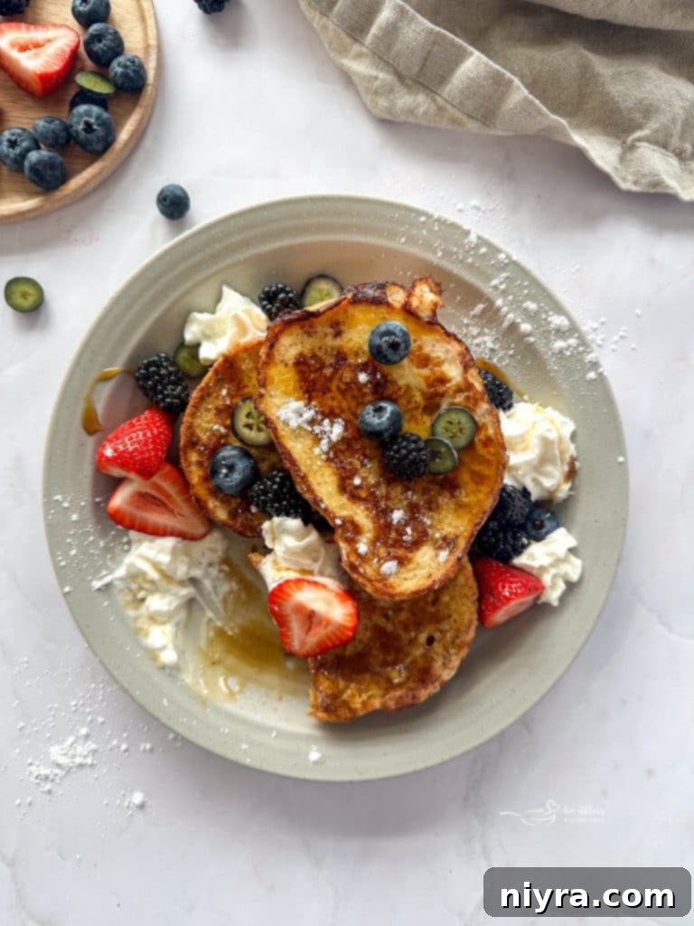 French toast slices with various toppings including berries, whipped cream, and syrup, inviting a 'pin it' action.