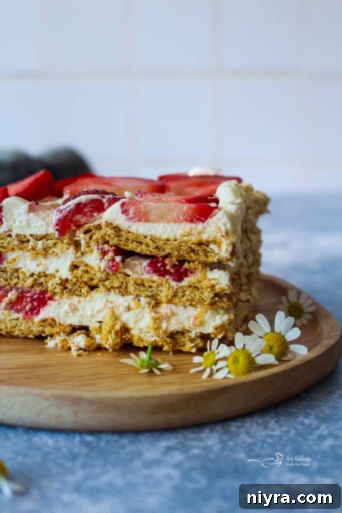 Old Fashioned Strawberry Icebox Cake with layers of graham crackers, strawberries, and whipped cream.