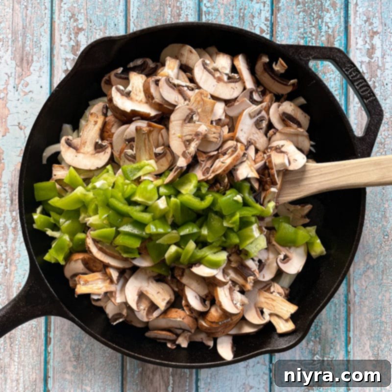 Loaded Philly Cheesesteak Peppers 10 Mushrooms and peppers sizzling in a skillet