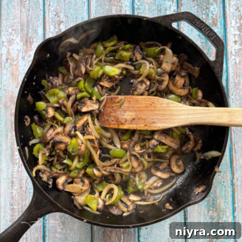 Loaded Philly Cheesesteak Peppers 11 Sautéing the mushrooms, peppers, and onions in a pan