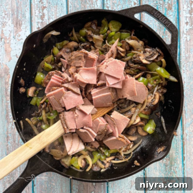 Loaded Philly Cheesesteak Peppers 12 Adding sliced roast beef to the caramelized mushroom and pepper mixture