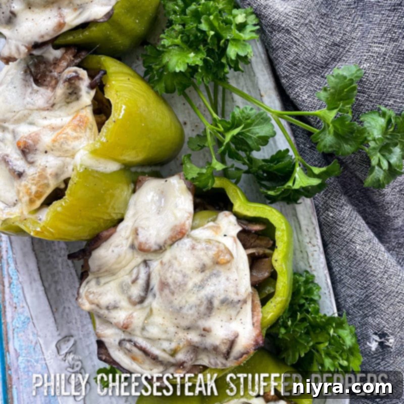 Loaded Philly Cheesesteak Peppers 20 Philly Cheesesteak Stuffed Peppers with text overlay, ready to cook