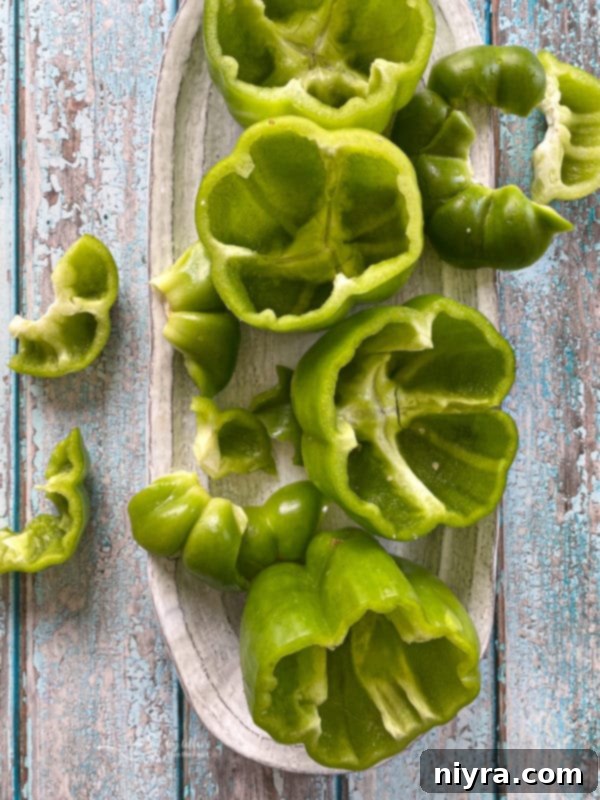 Loaded Philly Cheesesteak Peppers 6 Fresh green bell peppers on a plate, ready for prep