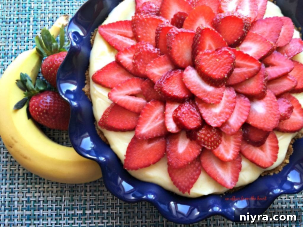 Delicious Strawberry Banana Cream Pie with a buttery graham cracker crust and fresh fruit