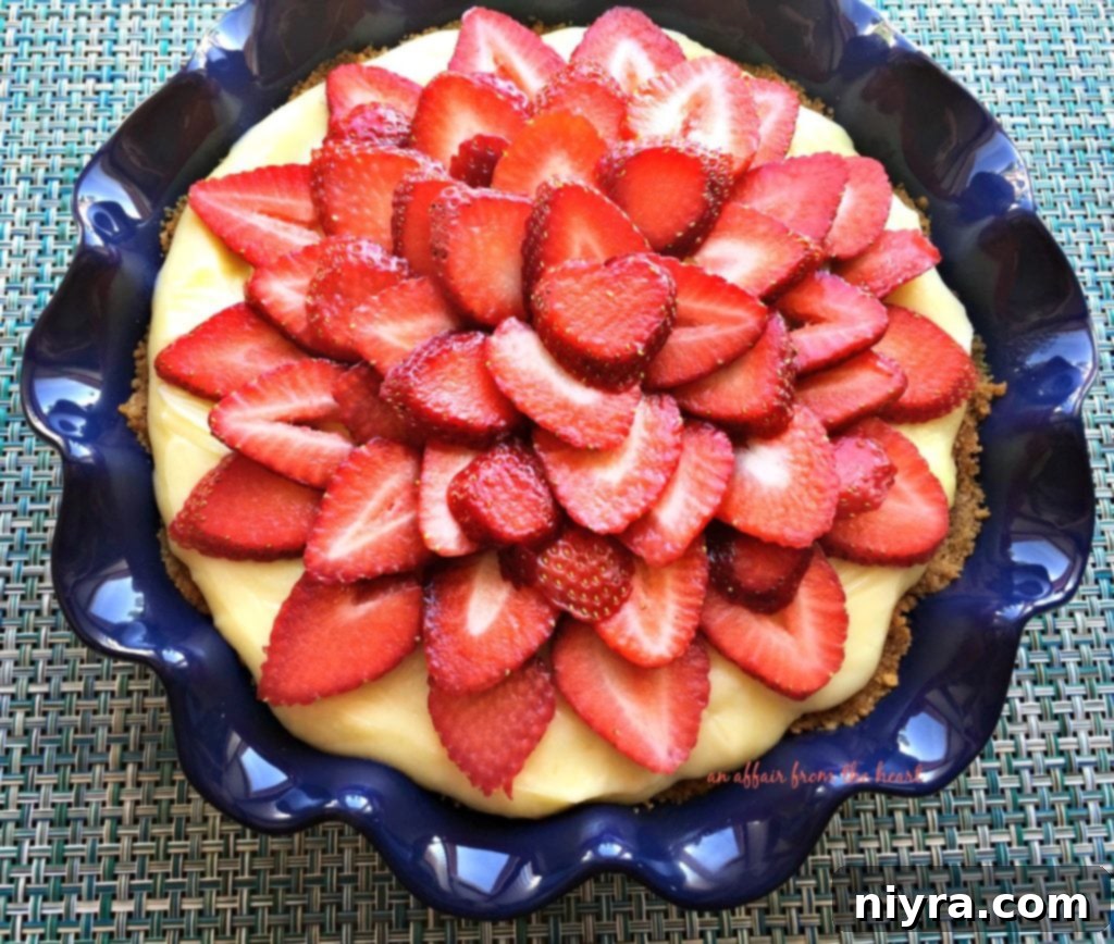 Close-up of Strawberry Banana Cream Pie slices with fresh strawberries arranged on top