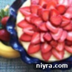 Extreme close-up of Strawberry Banana Cream Pie, showing rich texture and vibrant fruit