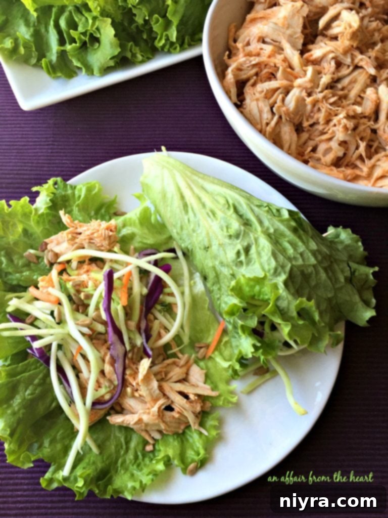 Crisp Buffalo Chicken Lettuce Wraps 18 Overhead view of a white bowl with buffalo chicken and a plate with assembled Buffalo Chicken Lettuce Wraps