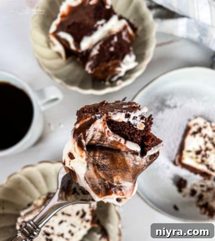 Chocolate pudding poured over a poked chocolate cake, before chilling