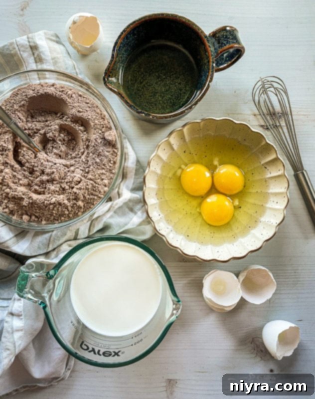 Chocolate pudding being spread over a poke cake, filling the holes