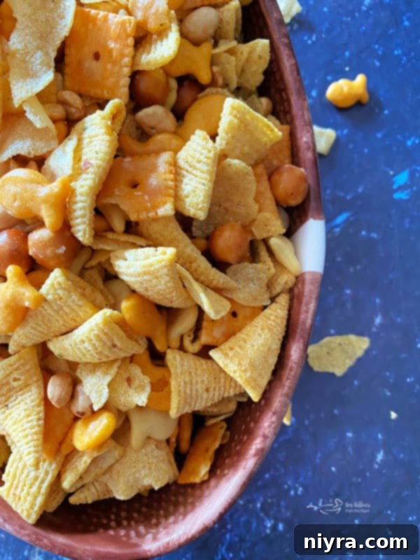 Touchdown Snack Mix Video 3 A close-up of the delicious Touchdown Snack Mix, showing a variety of crackers, pretzels, and nuts coated in a flavorful seasoning.