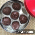 overhead of Peanut Butter Chocolate Chip Cookie Dough Truffles in a candy tin
