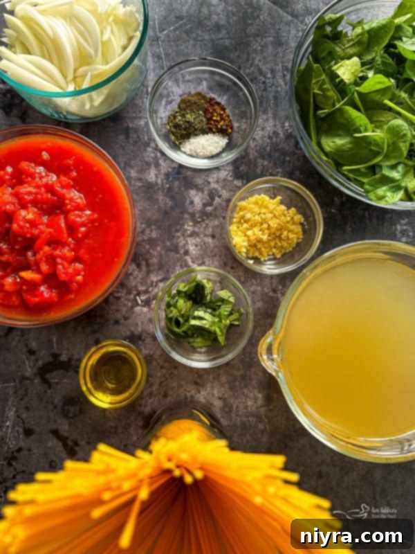 One-Pot Italian Magic 5 Fresh ingredients laid out for Italian Wonderpot Pasta, including spinach, tomatoes, and basil