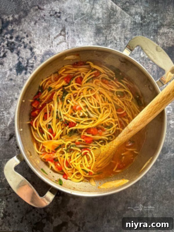 One-Pot Italian Magic 8 Italian Wonderpot Pasta simmering on the stove, half cooked