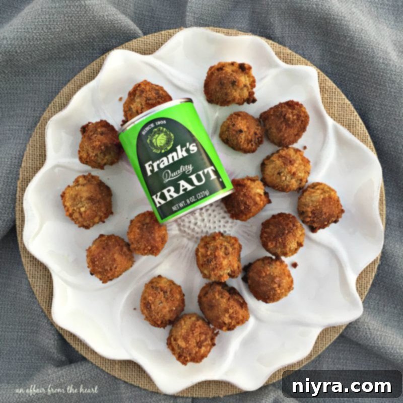 A trio of freshly fried Sauerkraut Balls on a white background, highlighting their golden crispness.
