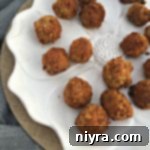 Sauerkraut Balls on a white serving dish with text "Sauerkraut balls"