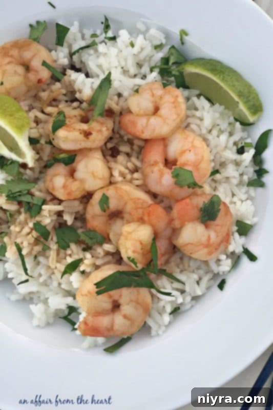 Zesty Sesame Cilantro Shrimp 4 A bowl of Sesame Cilantro Shrimp with fresh lime slices and herbs