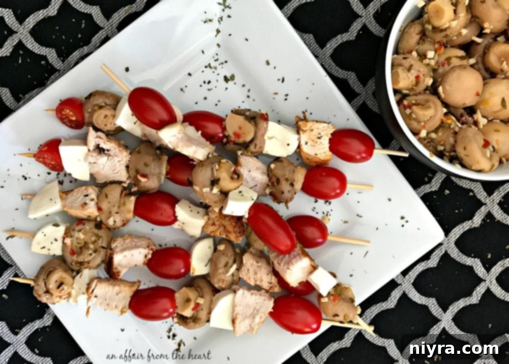 Delicious Italian Chicken and Marinated Mushroom Appetizer Skewers arranged beautifully on a platter, perfect for parties and holiday gatherings.