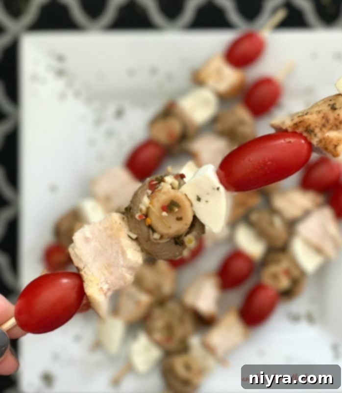 Beautifully presented Italian Chicken and Mushroom Skewers on a white serving plate, ready for a party.