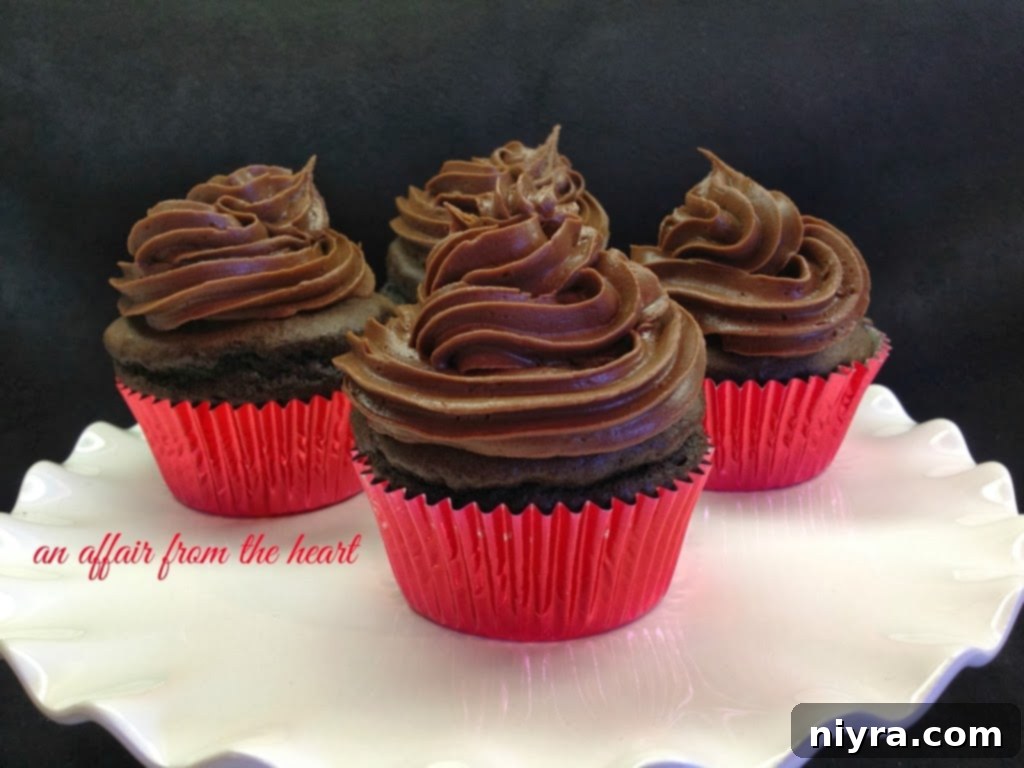 Close-up of a chocolate cupcake with a generous swirl of cream filling piped on top