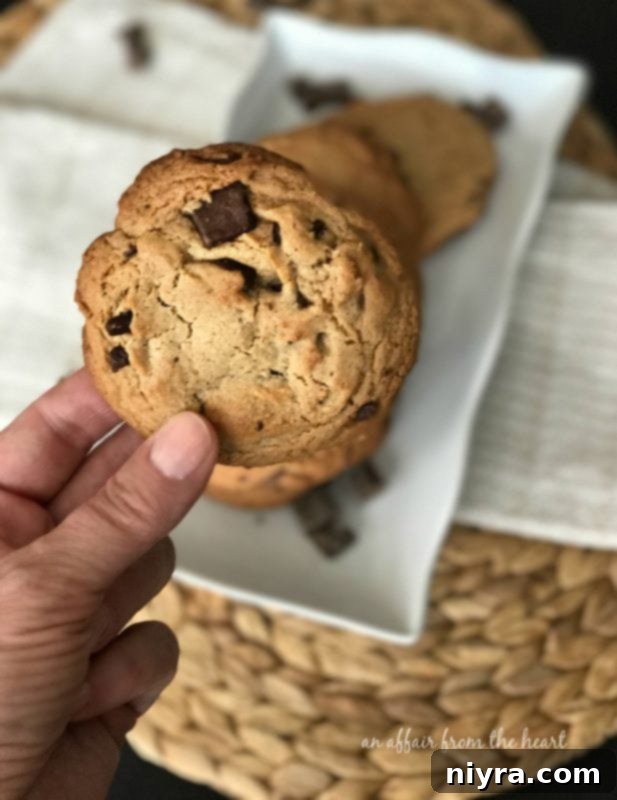 Decadent Peanut Butter Chocolate Chunk Cookies 6 Hand holding a large Peanut Butter Chocolate Chunk Cookie