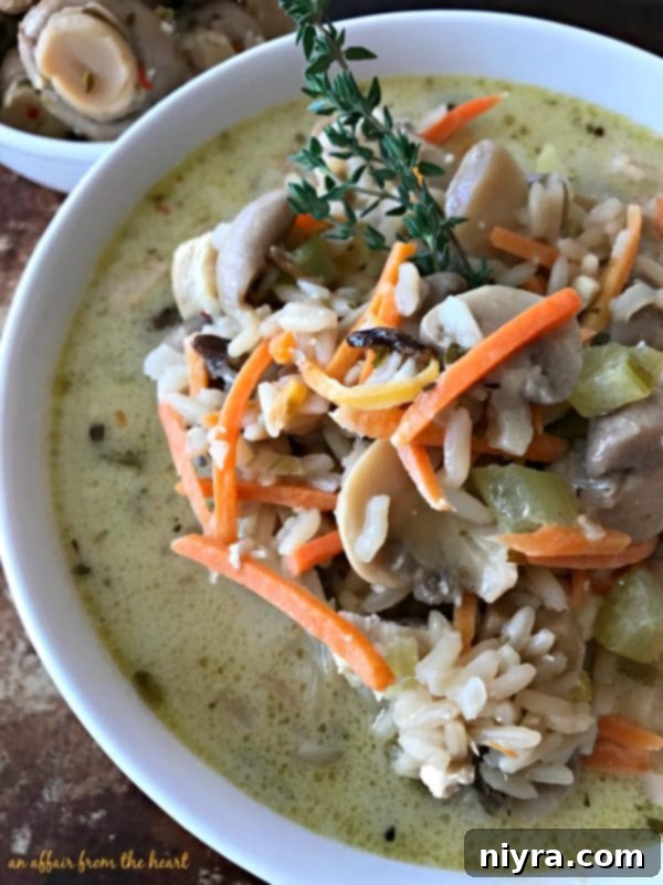Chicken and vegetables simmering in broth for Wild Rice Soup