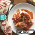 overhead of Spinach & Artichoke Stuffed Shells on a white plate