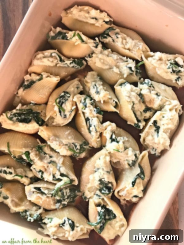 Jumbo pasta shells expertly stuffed with filling and placed in a baking dish