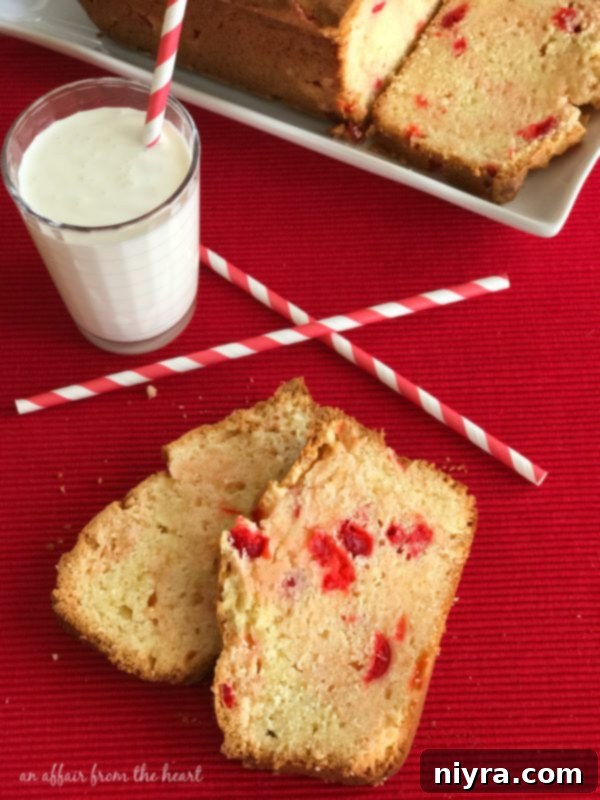 A freshly baked, golden-brown loaf of Cherry Cheese Bread, still warm and inviting, cooling on a wire rack on a kitchen counter.
