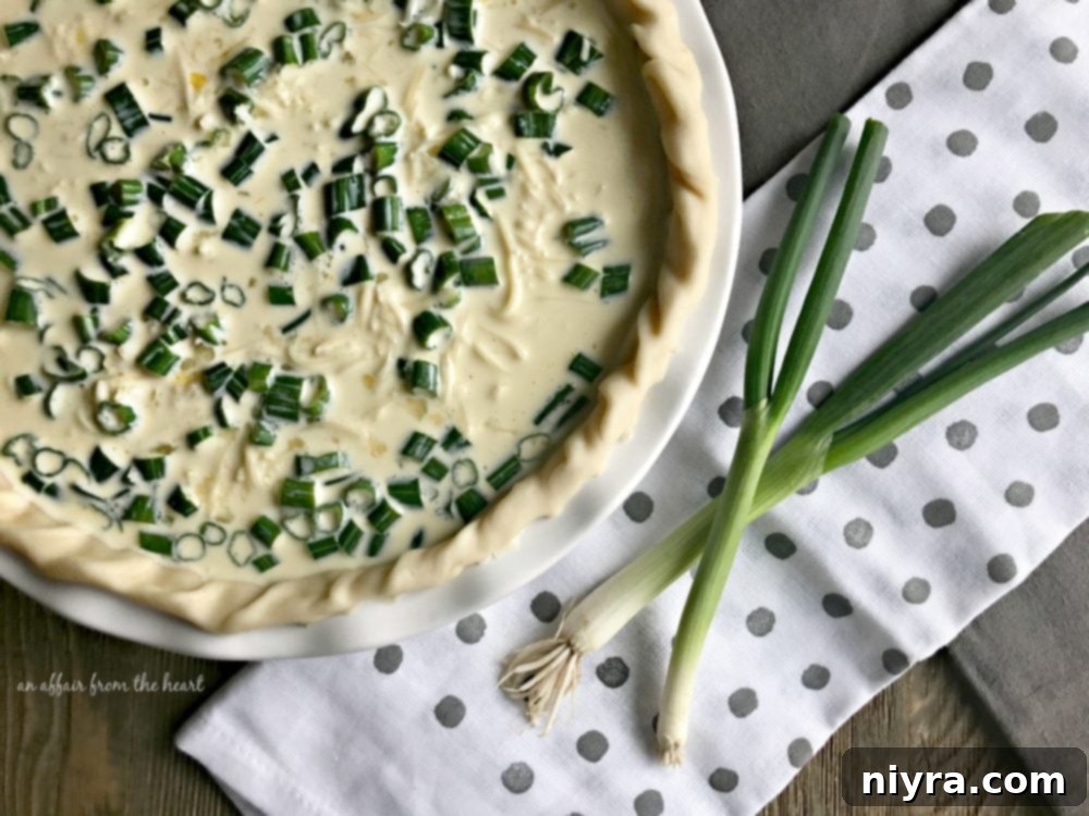 Layered ingredients – Swiss cheese, corned beef, sauerkraut – in a pie crust