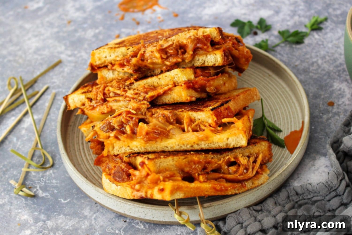 BBQ Pulled Pork Grilled Cheese sandwich being pulled apart, showing gooey cheese and tender pork.