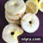 Bright Lemon Glazed Baked Donuts 11 Close up of Baked Glazed Lemon Donuts and one with a bite out of it