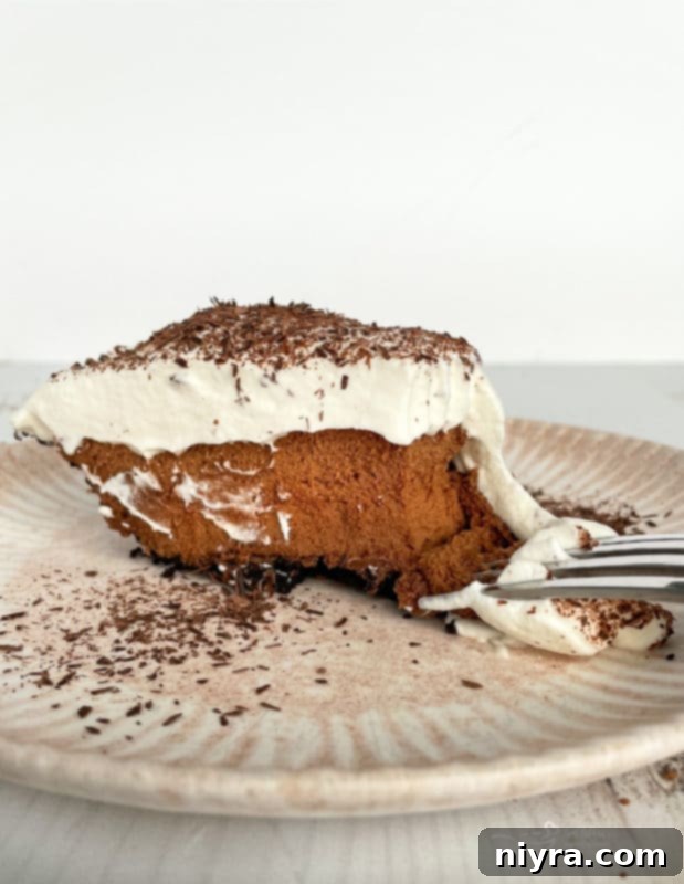 A single slice of French Silk Pie on a plate, showcasing its fluffy topping and rich filling.