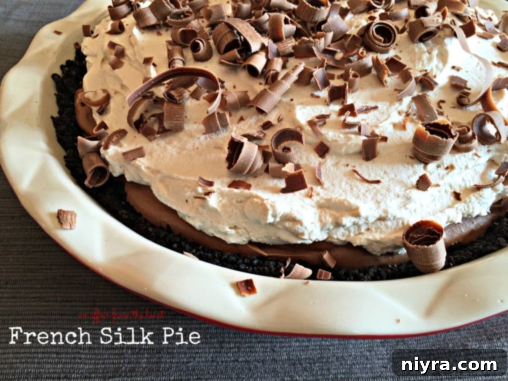 A whole French Silk Pie, elegantly garnished with whipped cream and chocolate shavings.