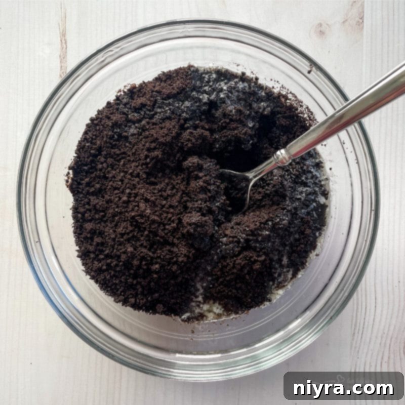 Crushed Oreo crumbs in a bowl, prepared for the pie crust.