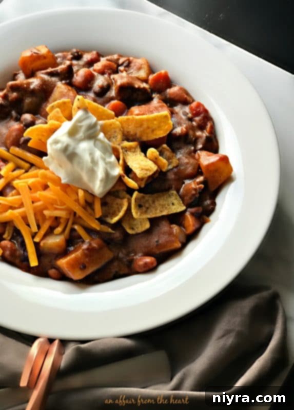 Ingredients for Taco Stew being prepared in a kitchen, including diced vegetables and beef.