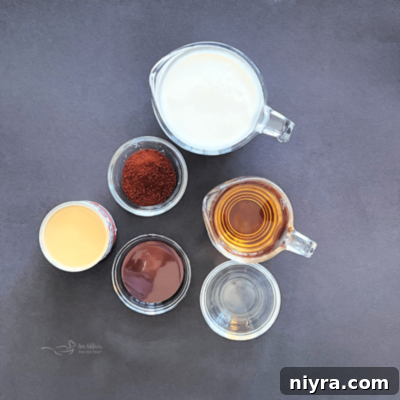 Velvet Irish Liqueur from Scratch 4 A selection of ingredients for homemade Irish Cream, including whiskey, chocolate syrup, instant coffee, and cream, neatly arranged.