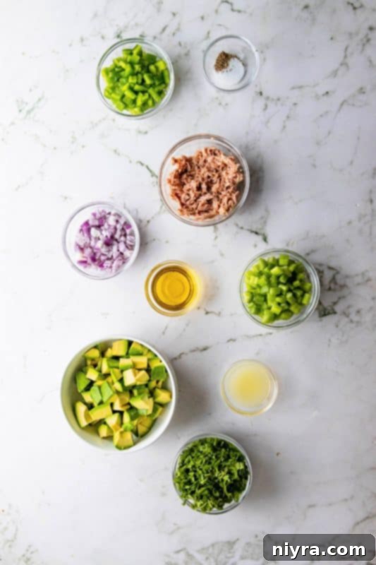 Avocado Tuna Salad served in a white bowl with fresh parsley garnish.