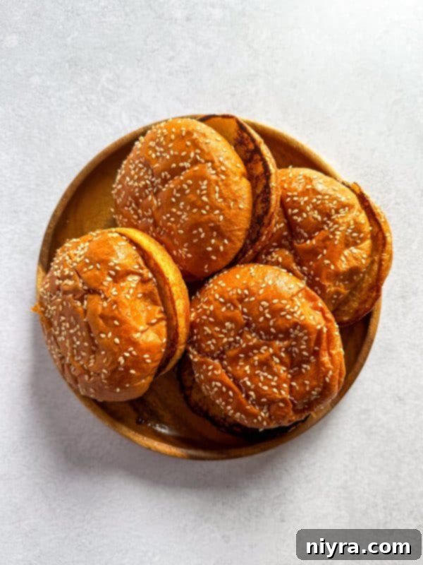 A close-up shot of a Mushroom Swiss Burger with a bite taken out, showing the melted cheese and mushrooms.