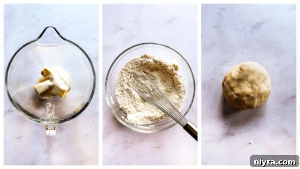 The shortbread dough being rolled out between parchment papers