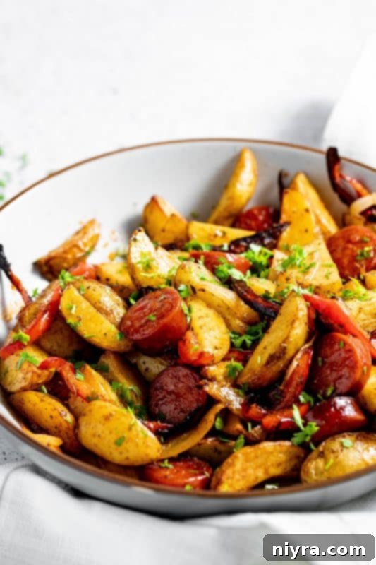 Close-up of vibrant Air Fryer Sausage and Potatoes with bell peppers and onions.