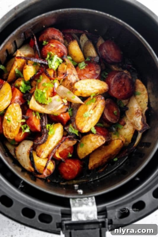 Freshly cooked Air Fryer Sausage and Potatoes garnished with parsley.