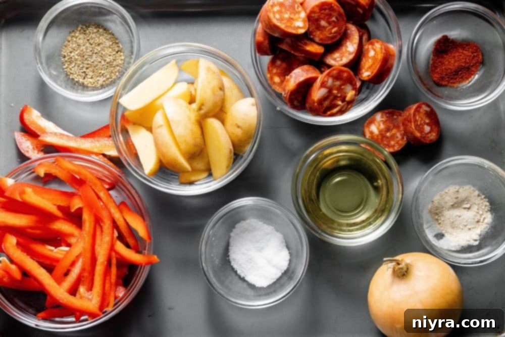 A bowl of ingredients including potatoes, onions, bell peppers, and spices for air fryer dish.