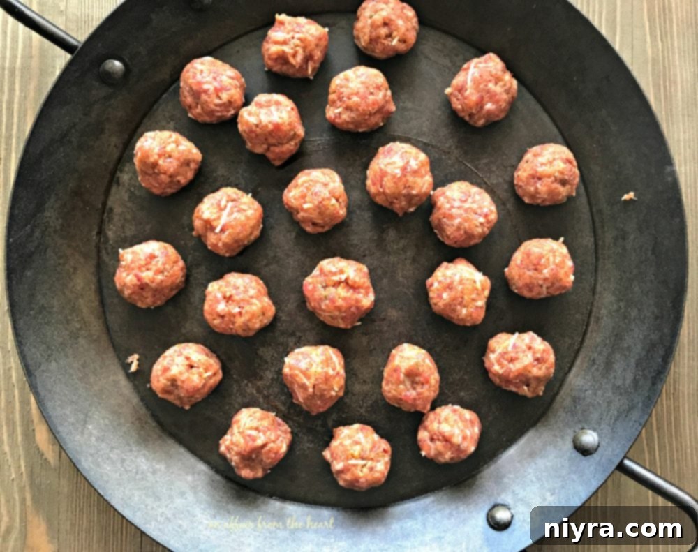 Browning Italian meatballs in a skillet