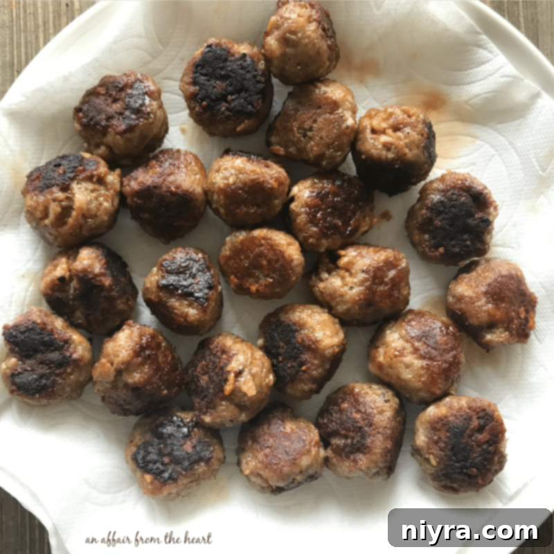 Browned meatballs resting on paper towels