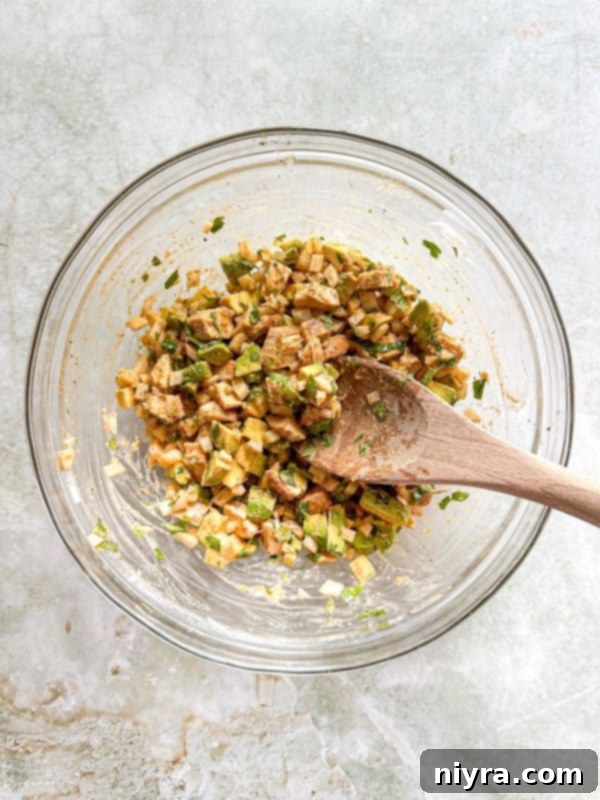 Third step: a spoon is stirring the ingredients in the large bowl to combine them thoroughly.