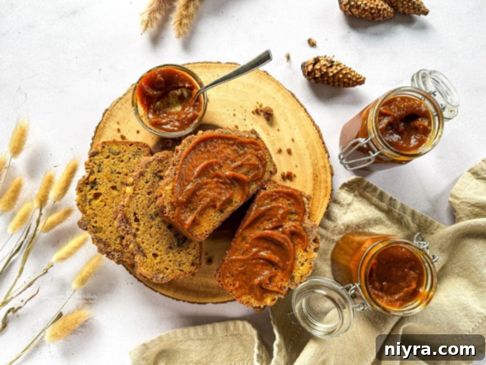 A saucepan on the stove filled with pumpkin butter ingredients being stirred.
